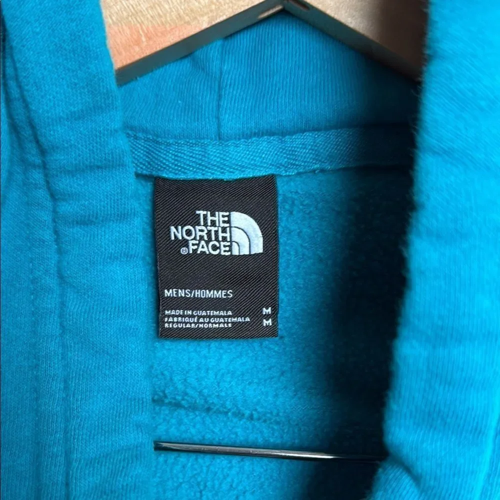The North Face Men's Blue Hoodie. Size Medium. Drawstring hood.